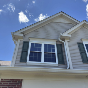 New double-hung windows with white trim installed on the front exterior of a Naperville home.
