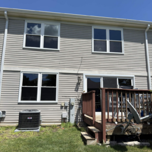 New windows and sliding patio door installed on the rear exterior of a home in Naperville.