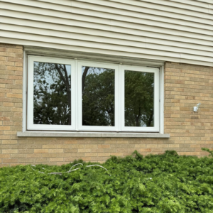 Three-panel white replacement window installed in a brick exterior wall in Lombard, Illinois.